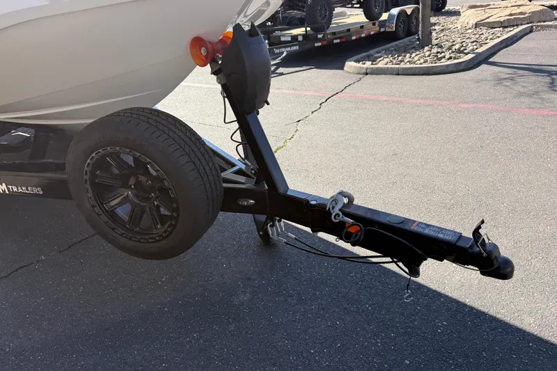 Slide: The Image of Trailer hitch of 2025 MB B52 25 Alpha boat on pavement. - 9