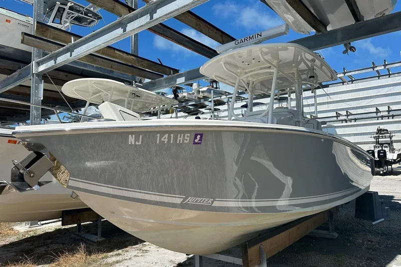 The Image of 2018 Jupiter 26 FS boat in storage, featuring sleek design and Garmin equipment. - 1