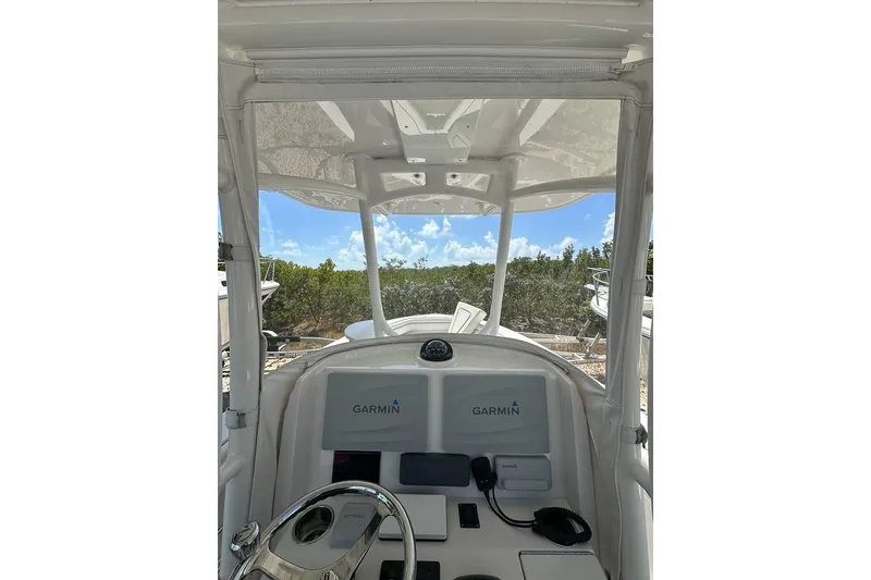 Slide: The Image of 2018 Jupiter 26 FS boat cockpit with Garmin navigation system, clear sky view. - 10