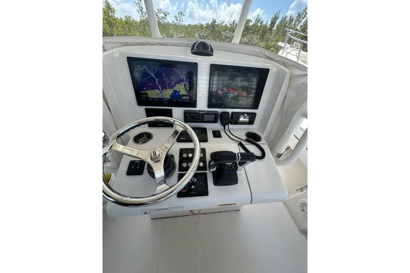 Slide: The Image of Helm of 2018 Jupiter 26 FS boat with navigation screens and controls. - 12