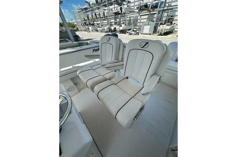 Slide: The Image of 2018 Jupiter 26 FS boat with dual white cushioned seats and steering wheel. - 14