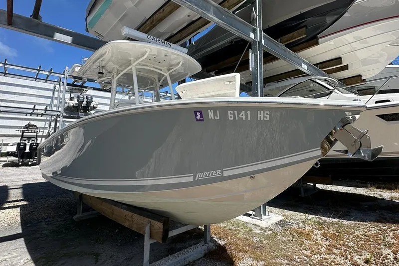 Slide: The Image of 2018 Jupiter 26 FS boat in storage, featuring sleek design and Garmin equipment. - 2