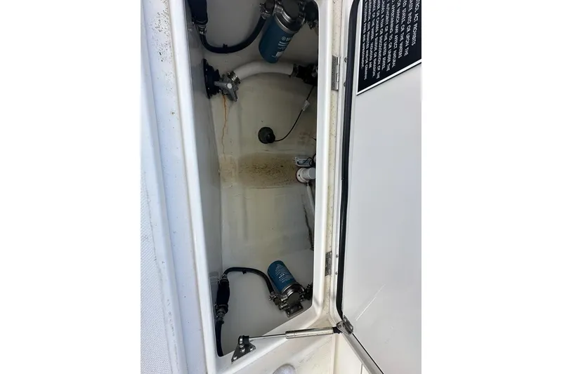 Slide: The Image of Open compartment of 2018 Jupiter 26 FS boat showing internal components and wiring. - 20