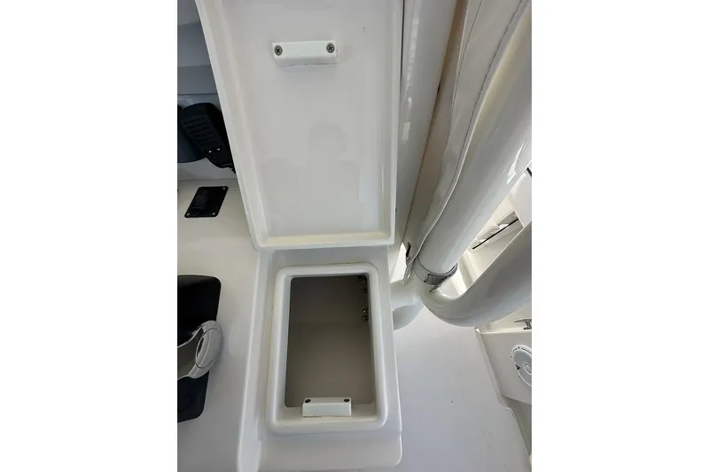 Slide: The Image of Open storage compartment on a 2018 Jupiter 26 FS boat, showcasing interior space. - 22