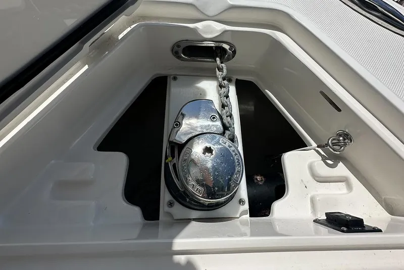 Slide: The Image of Anchor windlass system on a 2018 Jupiter 26 FS boat, featuring a metal chain. - 7