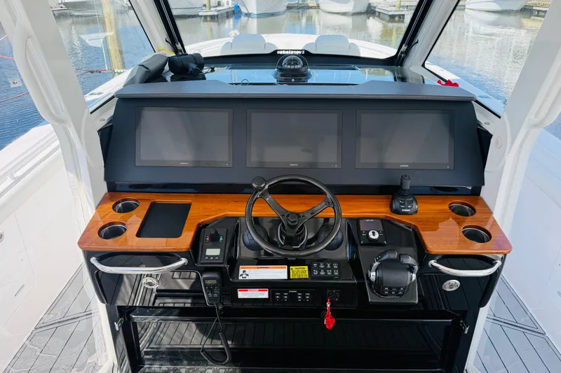 Slide: The Image of Helm of 2021 Everglades 395 Center Console with modern navigation displays and controls. - 1