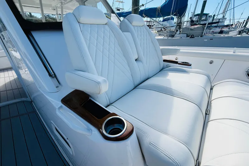 Slide: The Image of Luxurious white seating on 2021 Everglades 395 Center Console boat with cup holders. - 12
