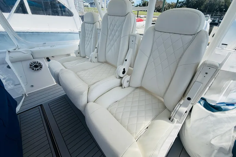 Slide: The Image of Luxurious white seating on 2021 Everglades 395 Center Console boat, featuring diamond stitching. - 13