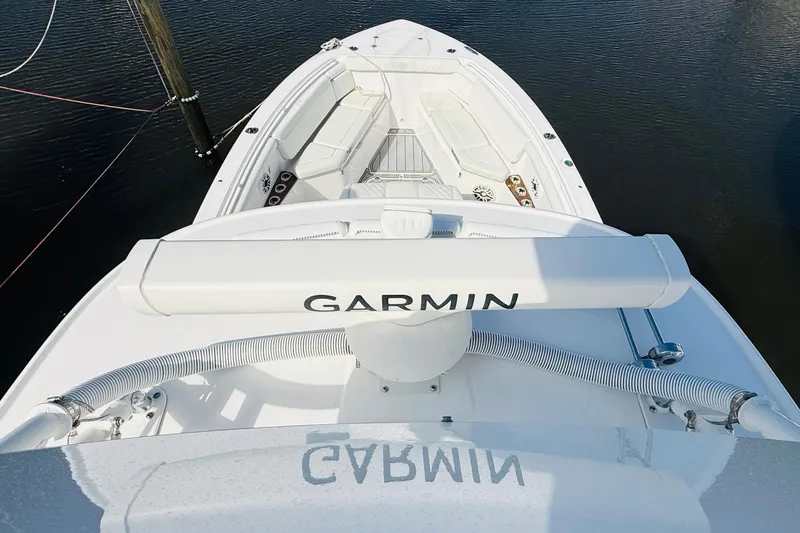 Slide: The Image of 2021 Everglades 395 Center Console boat with Garmin equipment, docked on calm water. - 15