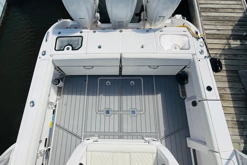 Slide: The Image of 2021 Everglades 395 Center Console boat deck with seating and storage compartments. - 16