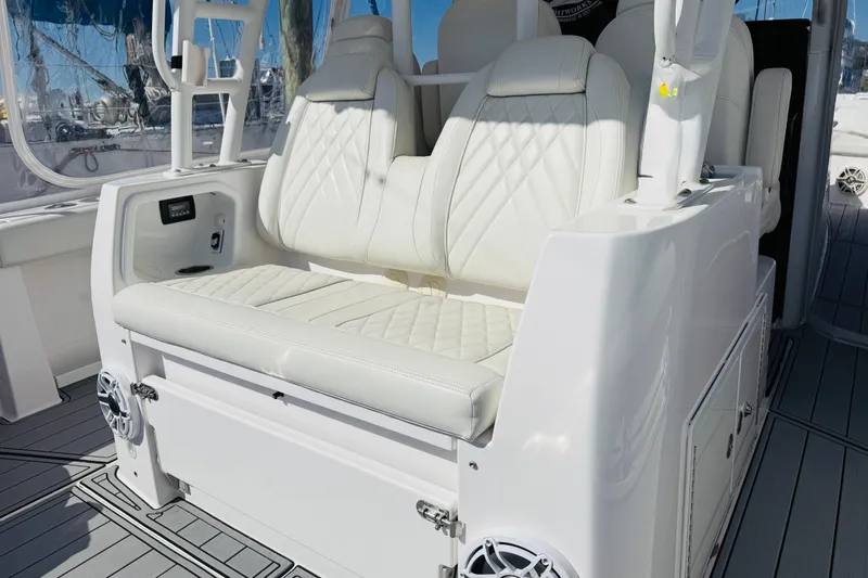 Slide: The Image of Luxurious seating on 2021 Everglades 395 Center Console boat, featuring white leather upholstery. - 2