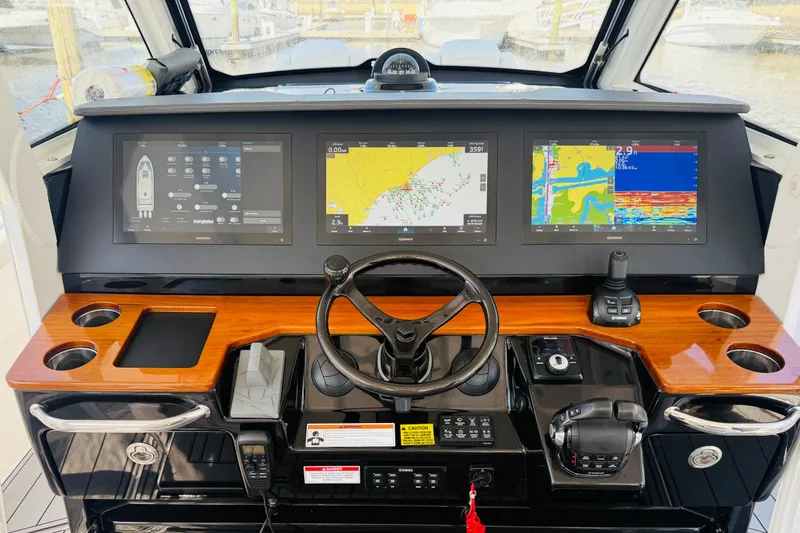 Slide: The Image of Cockpit of 2021 Everglades 395 Center Console with advanced navigation displays and controls. - 22