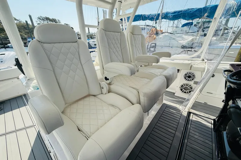Slide: The Image of Luxurious seating on 2021 Everglades 395 Center Console boat, featuring white quilted upholstery. - 25