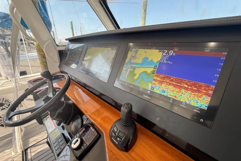 Slide: The Image of Dashboard of 2021 Everglades 395 Center Console with navigation screens and controls. - 28