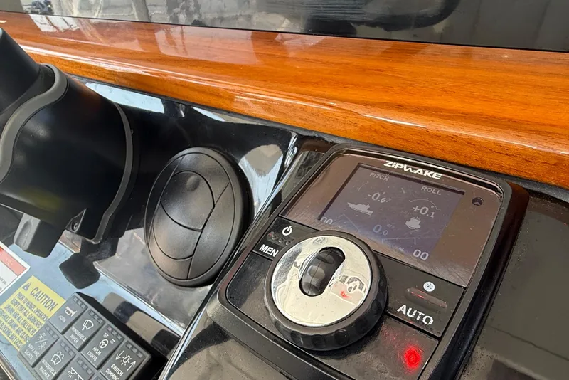 Slide: The Image of Control panel of 2021 Everglades 395 Center Console with Zipwake system. - 29