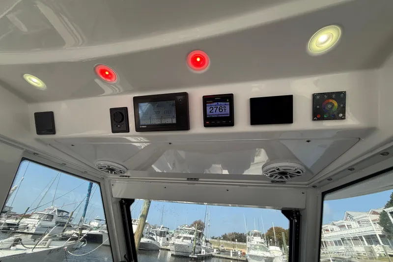 Slide: The Image of Interior view of 2021 Everglades 395 Center Console with control panel. - 32