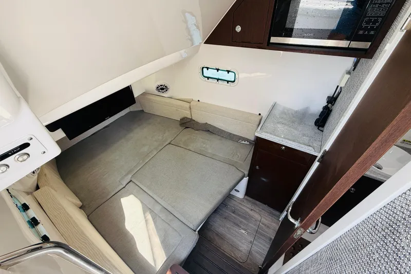 Slide: The Image of Interior of 2021 Everglades 395 Center Console with sleeping area and kitchenette. - 36