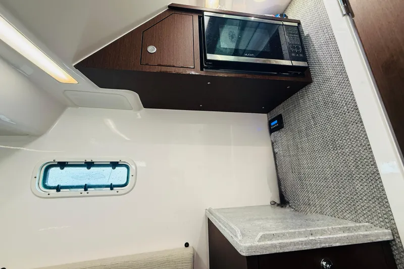 Slide: The Image of Interior of 2021 Everglades 395 Center Console with microwave and window. - 37