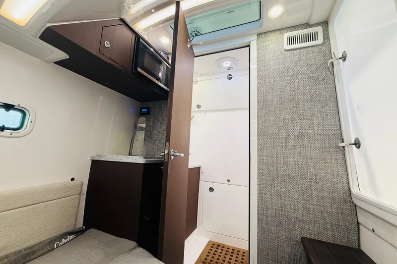 Slide: The Image of Interior of 2021 Everglades 395 Center Console boat with kitchenette and seating area. - 39