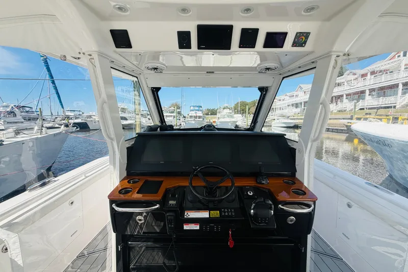 Slide: The Image of Cockpit view of 2021 Everglades 395 Center Console boat at marina. - 4