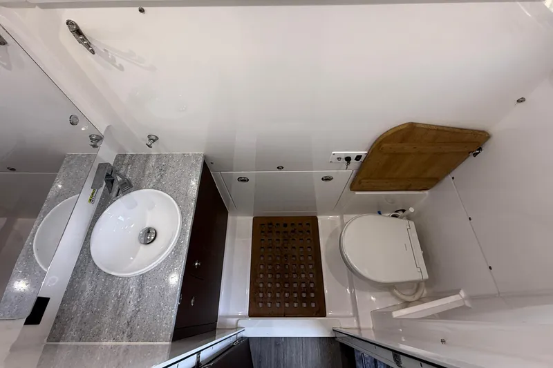 Slide: The Image of Modern bathroom interior of 2021 Everglades 395 Center Console boat, featuring sink and toilet. - 41