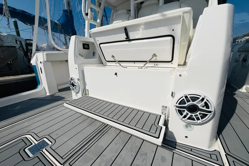 Slide: The Image of 2021 Everglades 395 Center Console boat interior with open storage and speakers. - 46