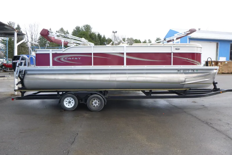 The Image of 2012 Crest 230SLR Classic pontoon boat on trailer, featuring red and silver design. - 1