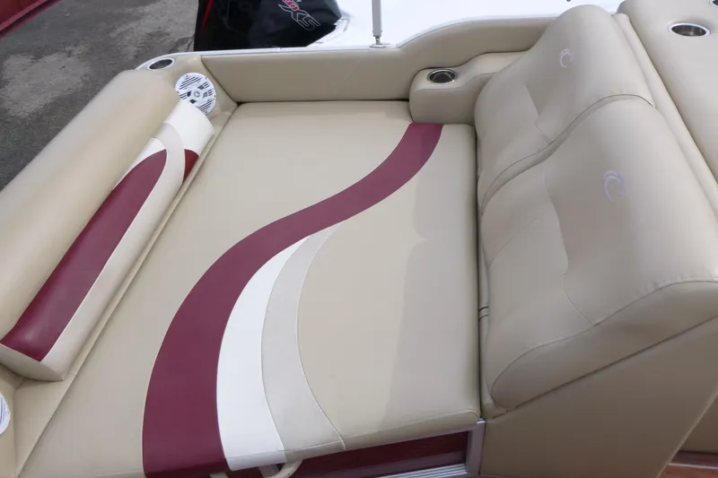 Slide: The Image of Luxurious seating on 2012 Crest 230SLR Classic boat with beige and maroon upholstery. - 11