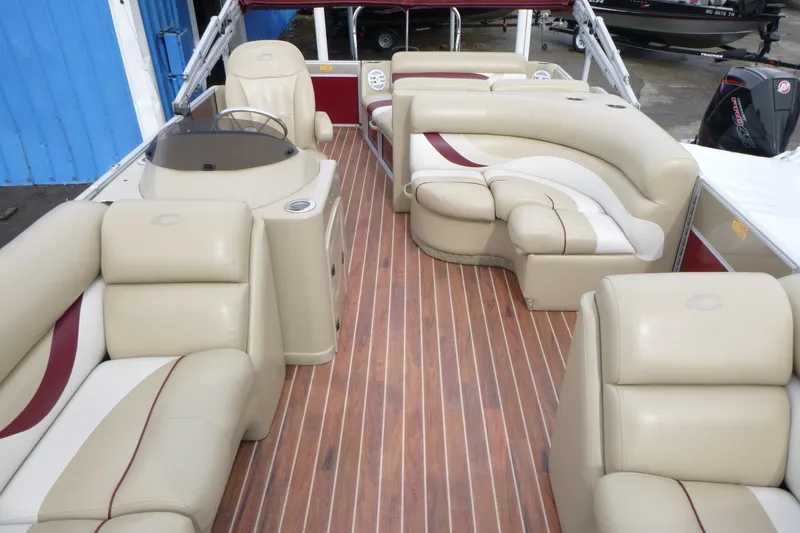 Slide: The Image of Luxurious interior of a 2012 Crest 230SLR Classic boat with plush seating and wood flooring. - 4