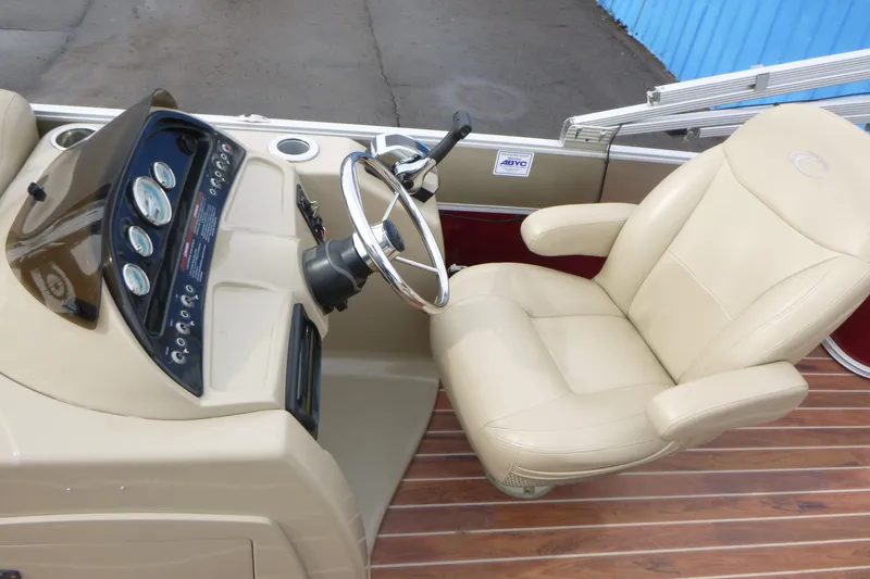 Slide: The Image of Steering console of 2012 Crest 230SLR Classic boat with beige captain's chair. - 9