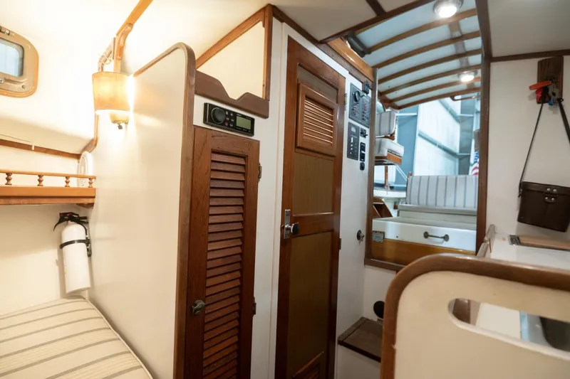 Slide: The Image of Interior of a 1986 Dyer Hardtop boat, featuring wood accents and nautical decor. - 10