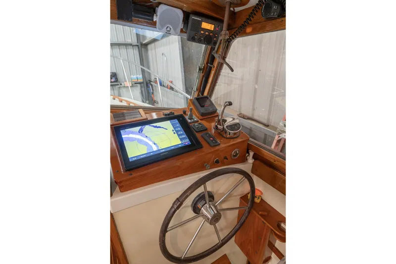 Slide: The Image of 1986 Dyer Hardtop boat cockpit with navigation equipment and steering wheel. - 12