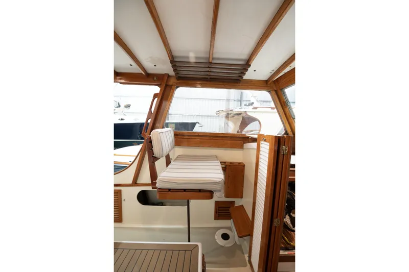 Slide: The Image of 1986 Dyer Hardtop interior with wooden accents and striped seating. - 15