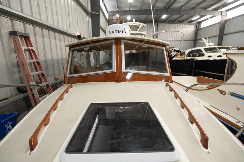 Slide: The Image of 1986 Dyer Hardtop boat in storage, featuring Garmin equipment and wooden accents. - 23