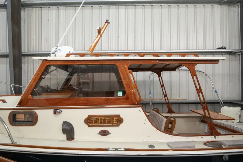Slide: The Image of 1986 Dyer Hardtop boat with wooden accents, docked indoors. - 28