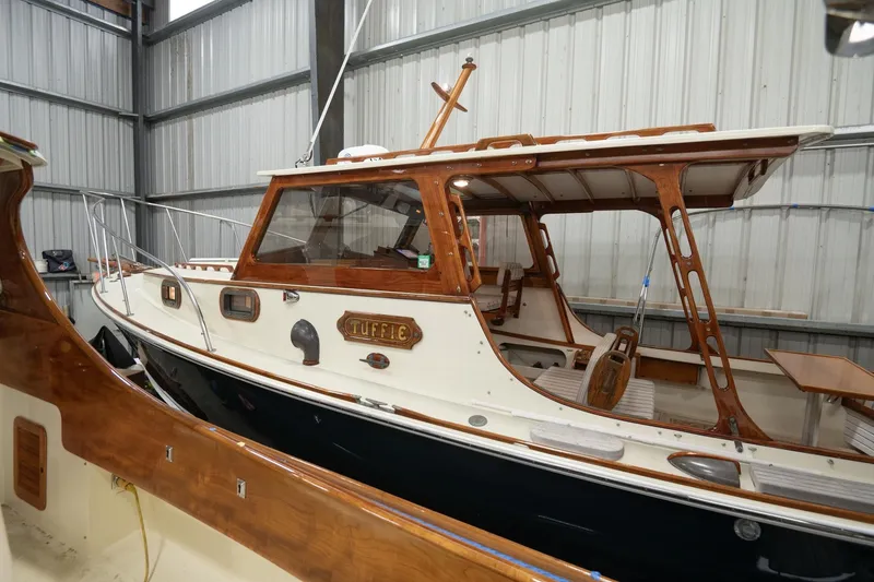 Slide: The Image of 1986 Dyer Hardtop boat in storage, featuring wooden accents and classic design. - 29