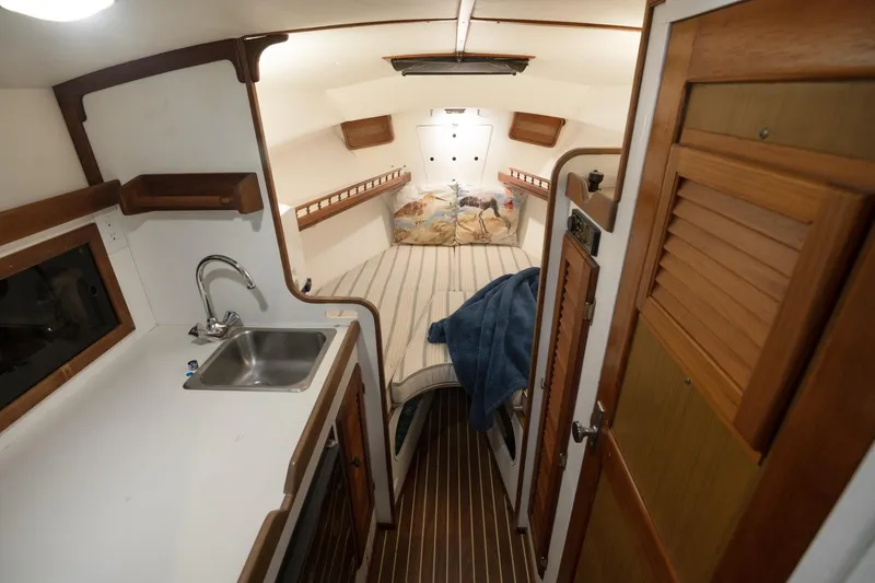 Slide: The Image of Interior of a 1986 Dyer Hardtop boat with cozy cabin and kitchenette. - 3