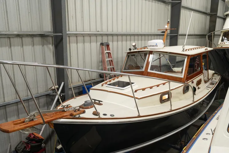 Slide: The Image of 1986 Dyer Hardtop boat in storage, featuring classic design and wooden accents. - 33