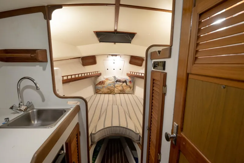 Slide: The Image of Interior of a 1986 Dyer Hardtop boat with cozy cabin and kitchenette. - 4