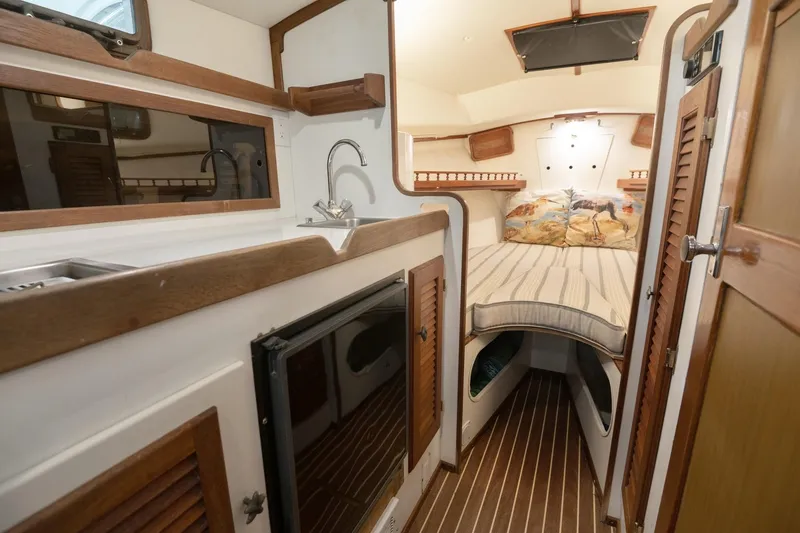 Slide: The Image of 1986 Dyer Hardtop interior with cozy cabin, bed, and kitchenette. - 7