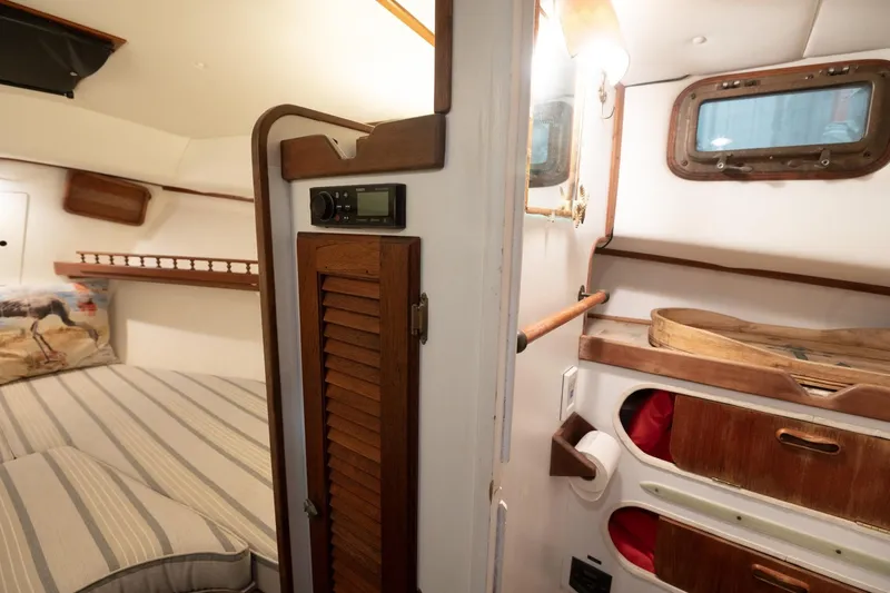 Slide: The Image of 1986 Dyer Hardtop boat interior with cozy cabin and wooden accents. - 9