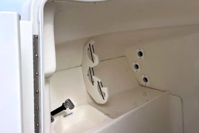 Slide: The Image of Interior view of a 2020 Key West 239 DFS boat compartment with rod holders. - 7