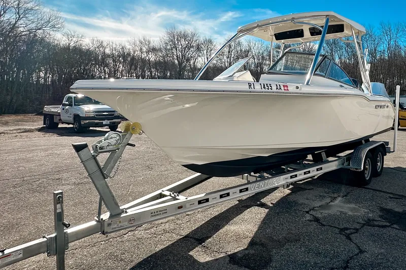 Slide: The Image of 2023 Key West 239 DFS boat on trailer in parking lot, sunny day. - 1
