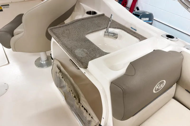 Slide: The Image of 2023 Key West 239 DFS boat interior with sink and seating area. - 12