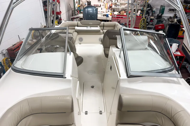 Slide: The Image of 2023 Key West 239 DFS boat interior with seating and windshield in a workshop. - 18