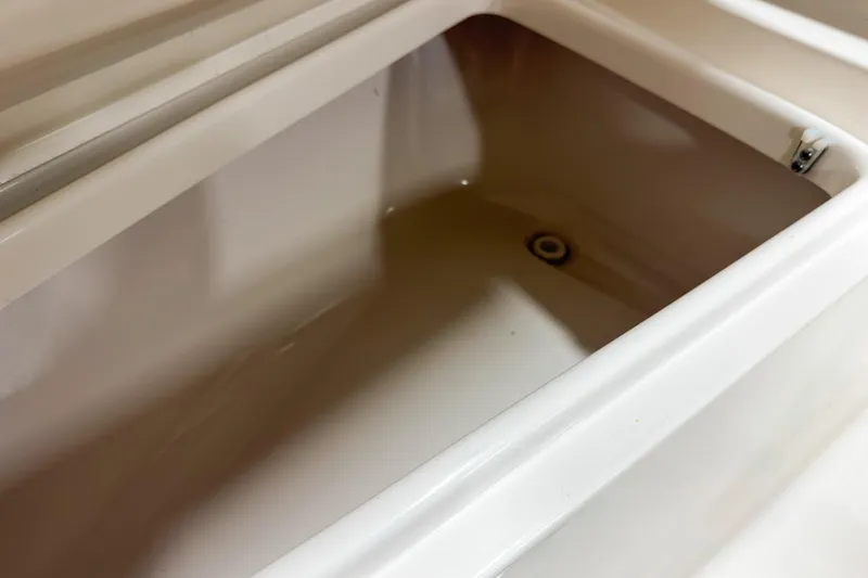 Slide: The Image of Open storage compartment in 2023 Key West 239 DFS boat, showcasing interior space. - 19