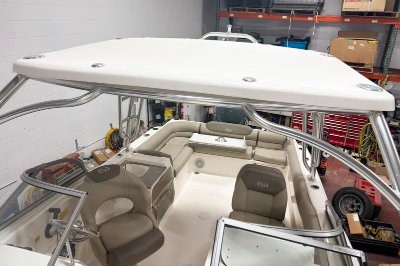 Slide: The Image of 2023 Key West 239 DFS boat interior with seating and storage in a workshop setting. - 22