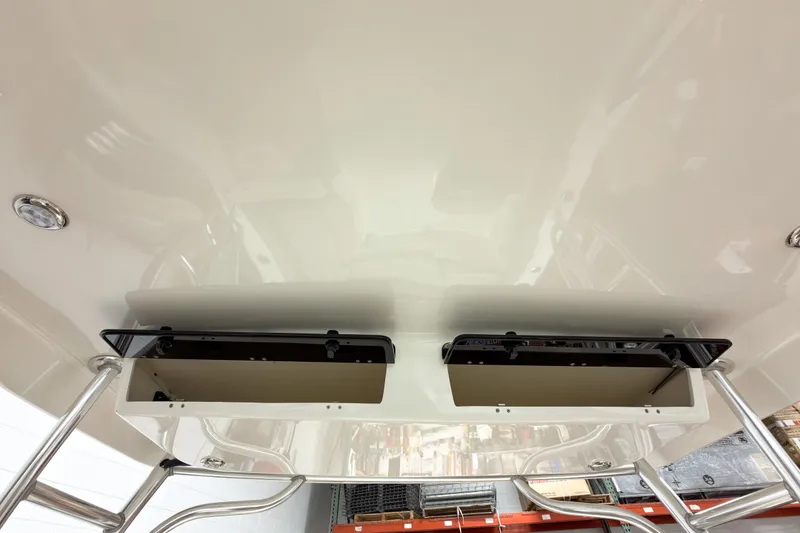 Slide: The Image of 2023 Key West 239 DFS boat interior ceiling with storage compartments and metal supports. - 23