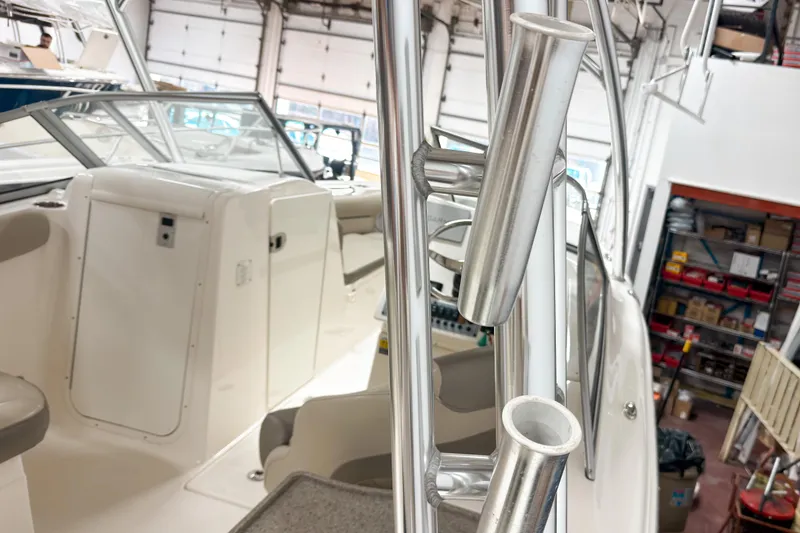 Slide: The Image of 2023 Key West 239 DFS boat interior with rod holders in a garage setting. - 24