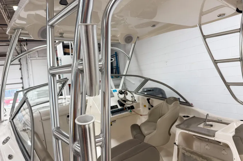Slide: The Image of 2023 Key West 239 DFS boat interior with helm, seating, and stainless steel fixtures. - 25